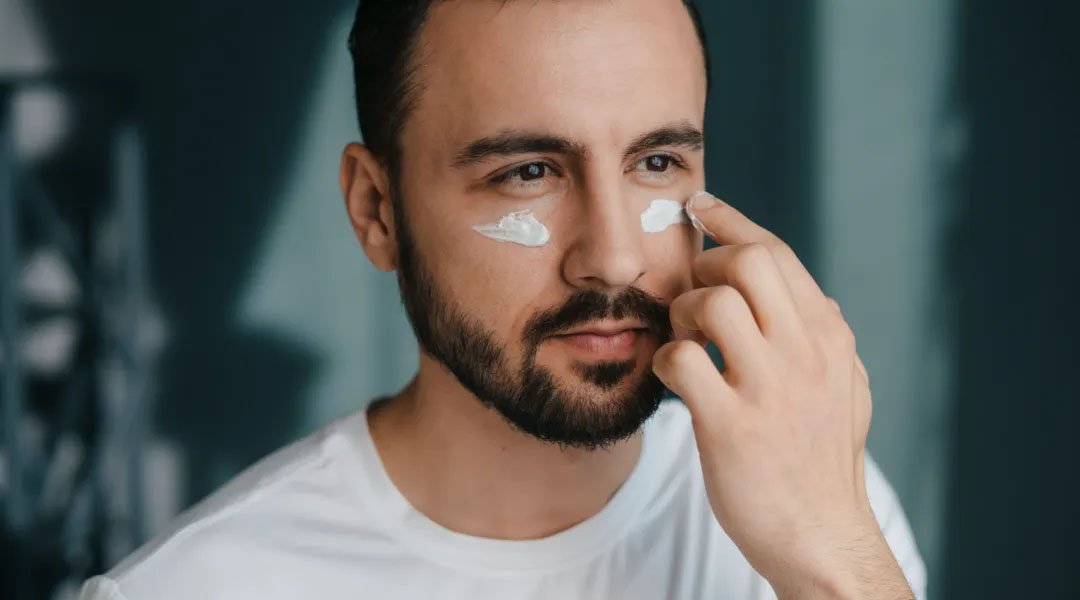 seorang pria memakai pelembap wajah pria